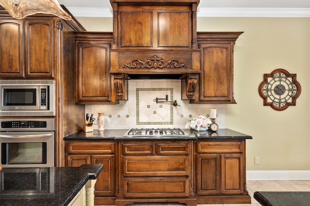 kitchen featuring crown molding, decorative backsplash, dark stone countertops, light tile patterned flooring, and stainless steel appliances