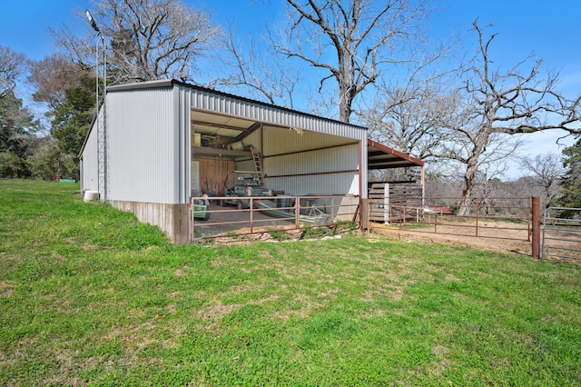 view of outbuilding featuring a lawn