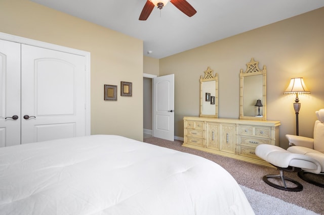 bedroom featuring ceiling fan, a closet, and carpet