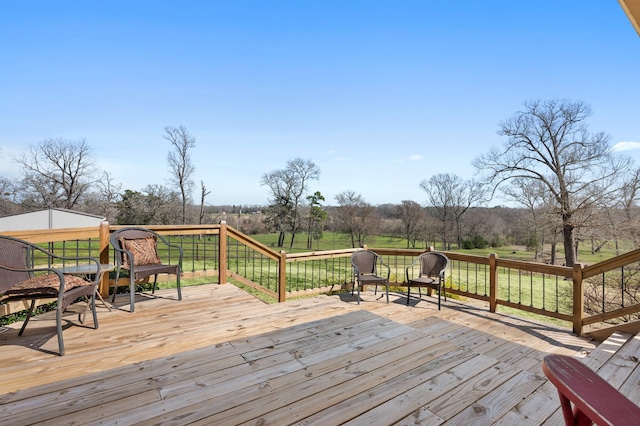 wooden terrace with a lawn