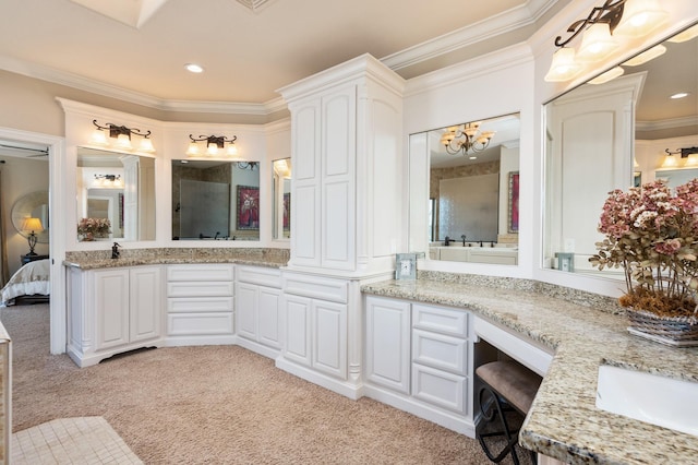 bathroom featuring vanity, an inviting chandelier, and ornamental molding