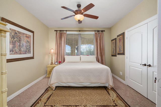 carpeted bedroom featuring ceiling fan and a closet