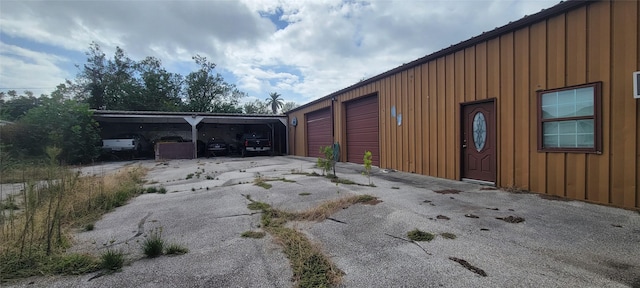 view of home's exterior featuring a garage and a carport