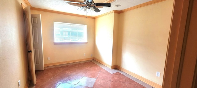 tiled spare room with ceiling fan and ornamental molding