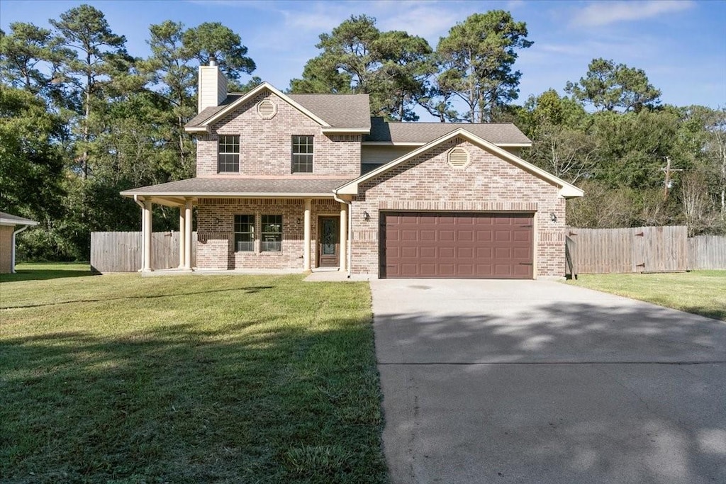 view of front facade with a front yard and a garage