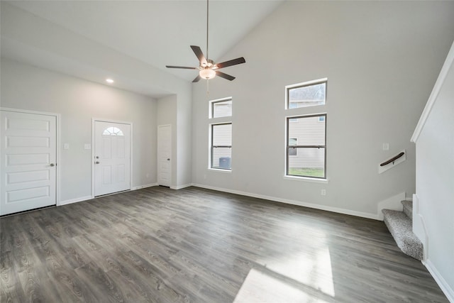 unfurnished living room featuring high vaulted ceiling, ceiling fan, and dark wood-type flooring