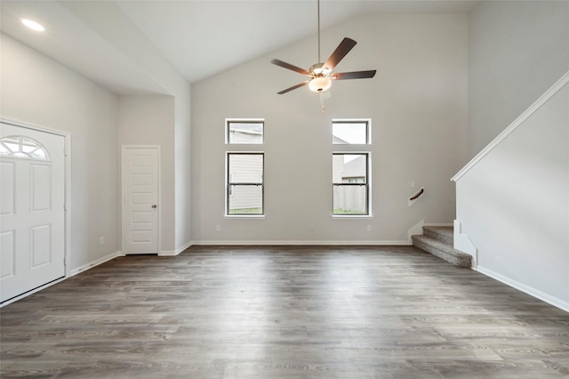 unfurnished living room featuring high vaulted ceiling, ceiling fan, and dark wood-type flooring