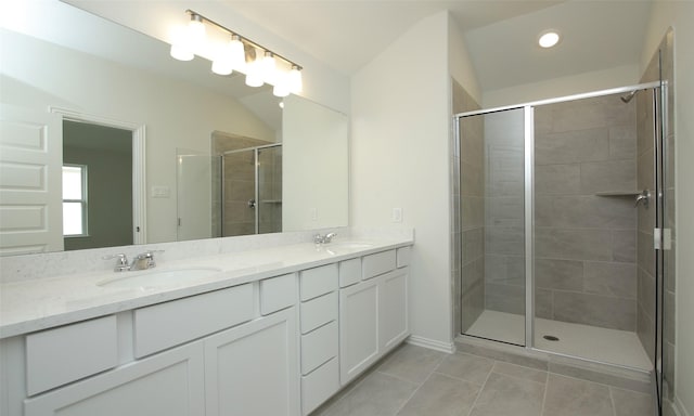 bathroom featuring vanity, tile patterned floors, a shower with door, and lofted ceiling