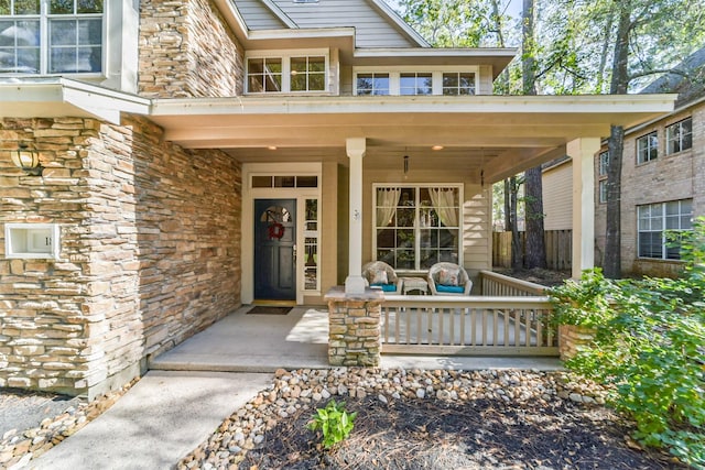 view of exterior entry featuring a porch