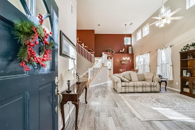 entrance foyer with hardwood / wood-style floors, high vaulted ceiling, and ceiling fan