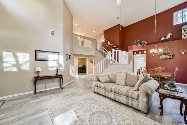 living room with a towering ceiling and hardwood / wood-style flooring