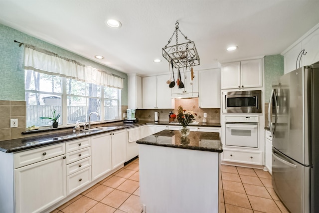 kitchen featuring appliances with stainless steel finishes, white cabinetry, and a kitchen island