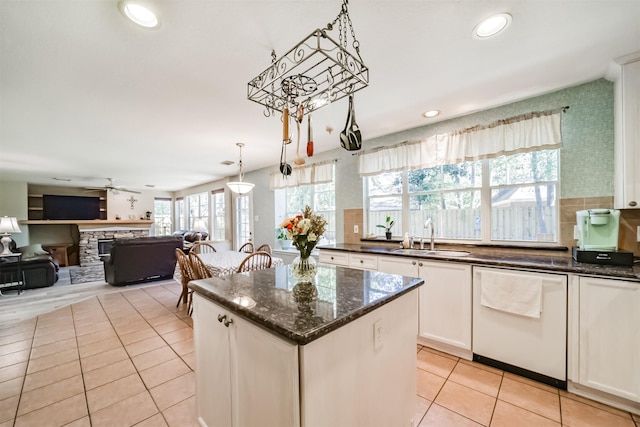 kitchen with white cabinets, dishwasher, sink, and a wealth of natural light