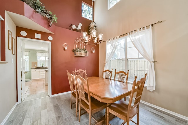 dining area featuring an inviting chandelier and light hardwood / wood-style flooring