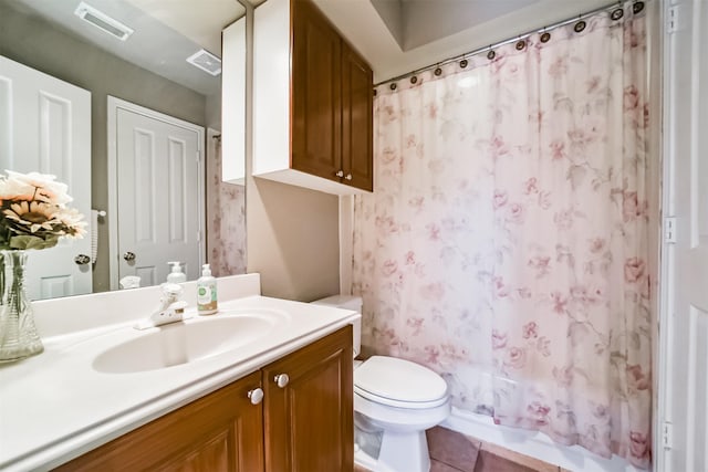 bathroom with tile patterned floors, vanity, and toilet