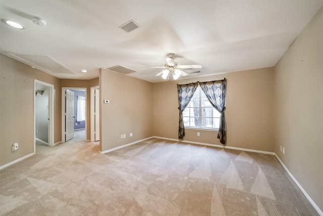 unfurnished room featuring light colored carpet and ceiling fan