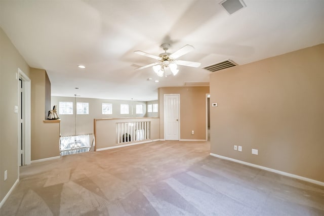 empty room with light colored carpet, ceiling fan, and lofted ceiling