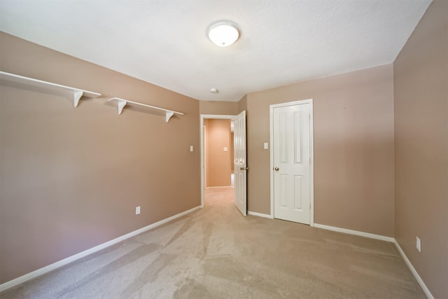 unfurnished bedroom with light carpet