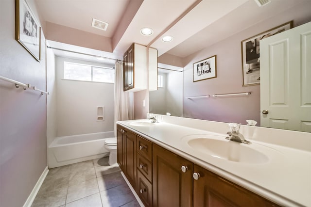 full bathroom with tile patterned floors, vanity, toilet, and shower / bath combo with shower curtain