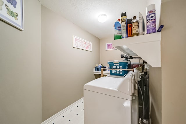 laundry room with independent washer and dryer and a textured ceiling