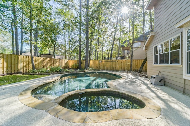 view of pool featuring an in ground hot tub and a patio