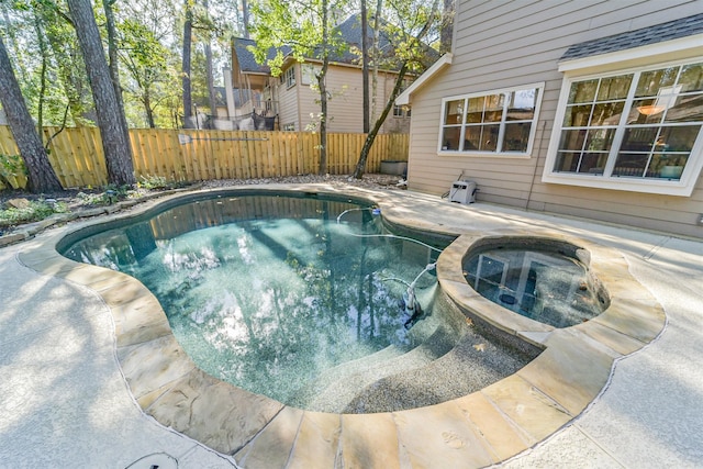 view of swimming pool featuring an in ground hot tub