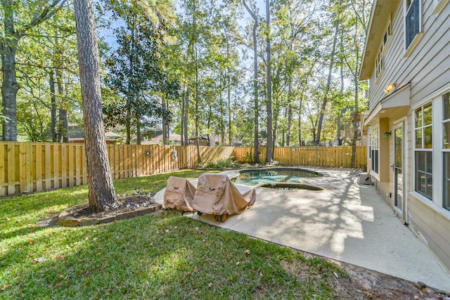 view of yard with a fenced in pool and a patio area