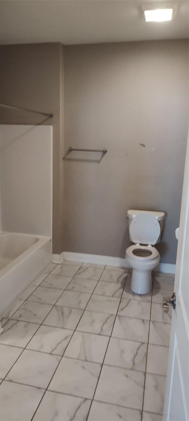 bathroom with toilet and a tub