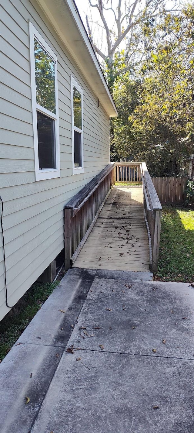 view of property exterior with a deck and a patio area