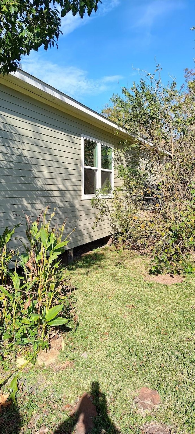 view of property exterior with a lawn