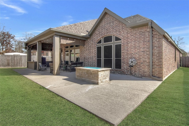 rear view of property with a lawn and a patio