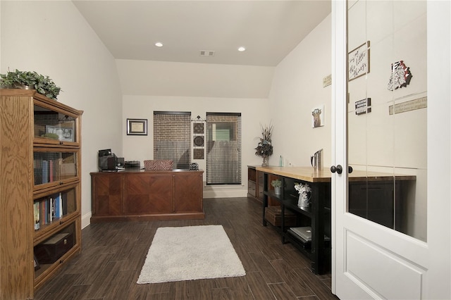 home office featuring dark wood-type flooring and vaulted ceiling