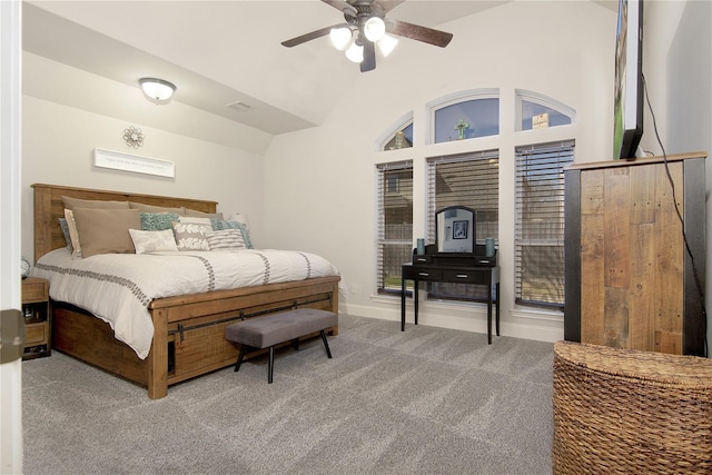 carpeted bedroom with ceiling fan and vaulted ceiling