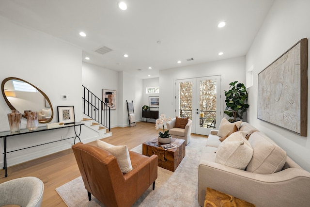 living room featuring light hardwood / wood-style flooring and french doors