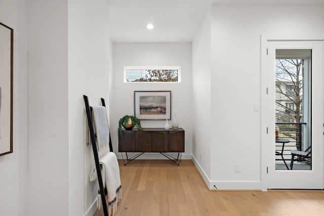 hallway with light hardwood / wood-style floors