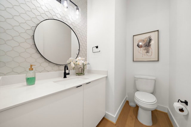 bathroom with vanity, wood-type flooring, and toilet