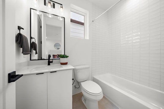 full bathroom with tiled shower / bath, vanity, toilet, and tile patterned flooring