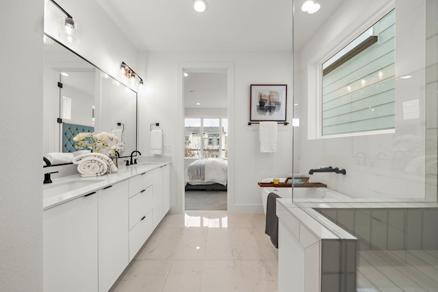 bathroom featuring vanity and a washtub