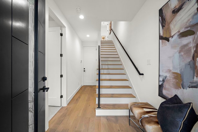 stairway with hardwood / wood-style flooring