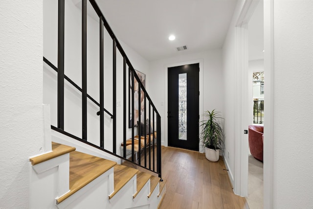 foyer with light hardwood / wood-style flooring and a healthy amount of sunlight