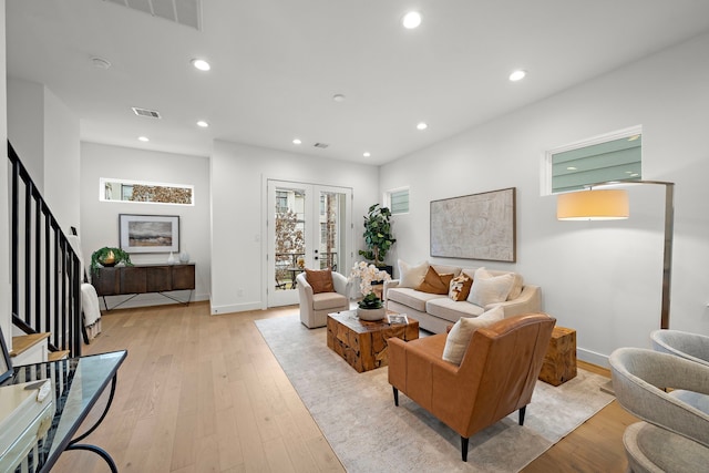 living room with french doors and light hardwood / wood-style flooring