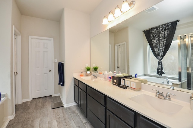 bathroom featuring vanity, hardwood / wood-style flooring, and a bathing tub