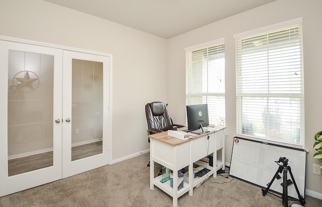 carpeted home office with french doors