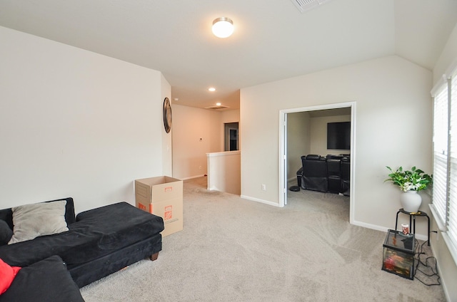 carpeted living room featuring vaulted ceiling