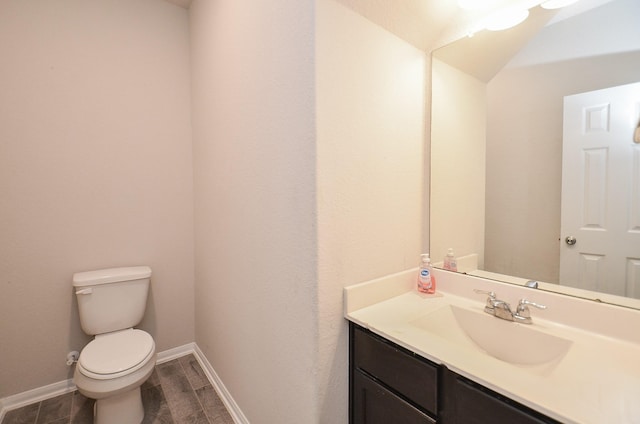 bathroom with vanity, wood-type flooring, and toilet