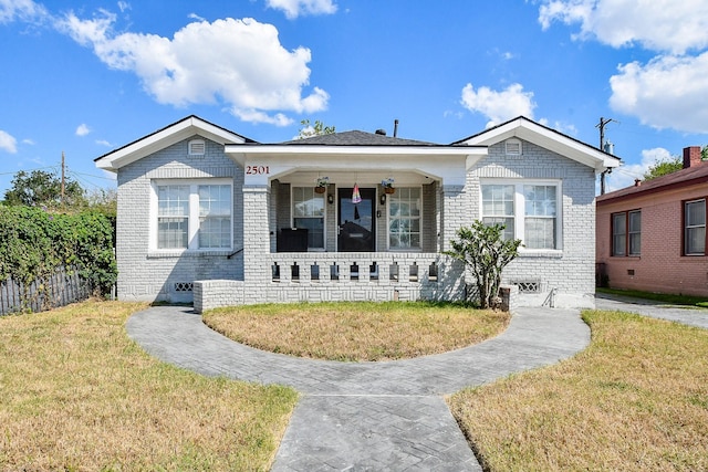 bungalow with a front lawn and a porch