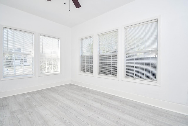 unfurnished sunroom with ceiling fan and a wealth of natural light