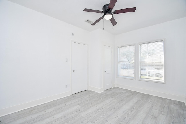 spare room featuring light hardwood / wood-style floors and ceiling fan