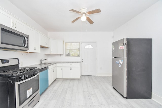 kitchen featuring white cabinetry, light hardwood / wood-style flooring, sink, and appliances with stainless steel finishes