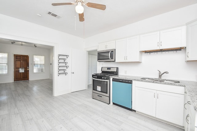 kitchen with sink, ceiling fan, light hardwood / wood-style floors, white cabinetry, and stainless steel appliances